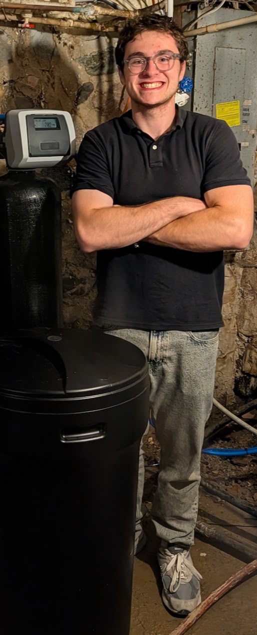 Jakob, owner of Better Life Water Solutions, with water treatment systems