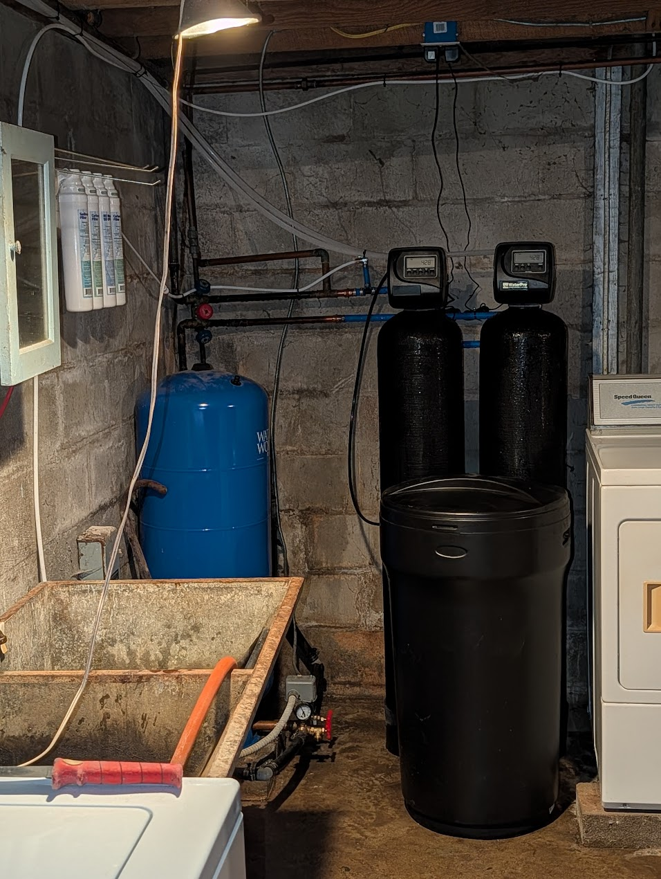 Water system installed next to a laundry area with pressure tank